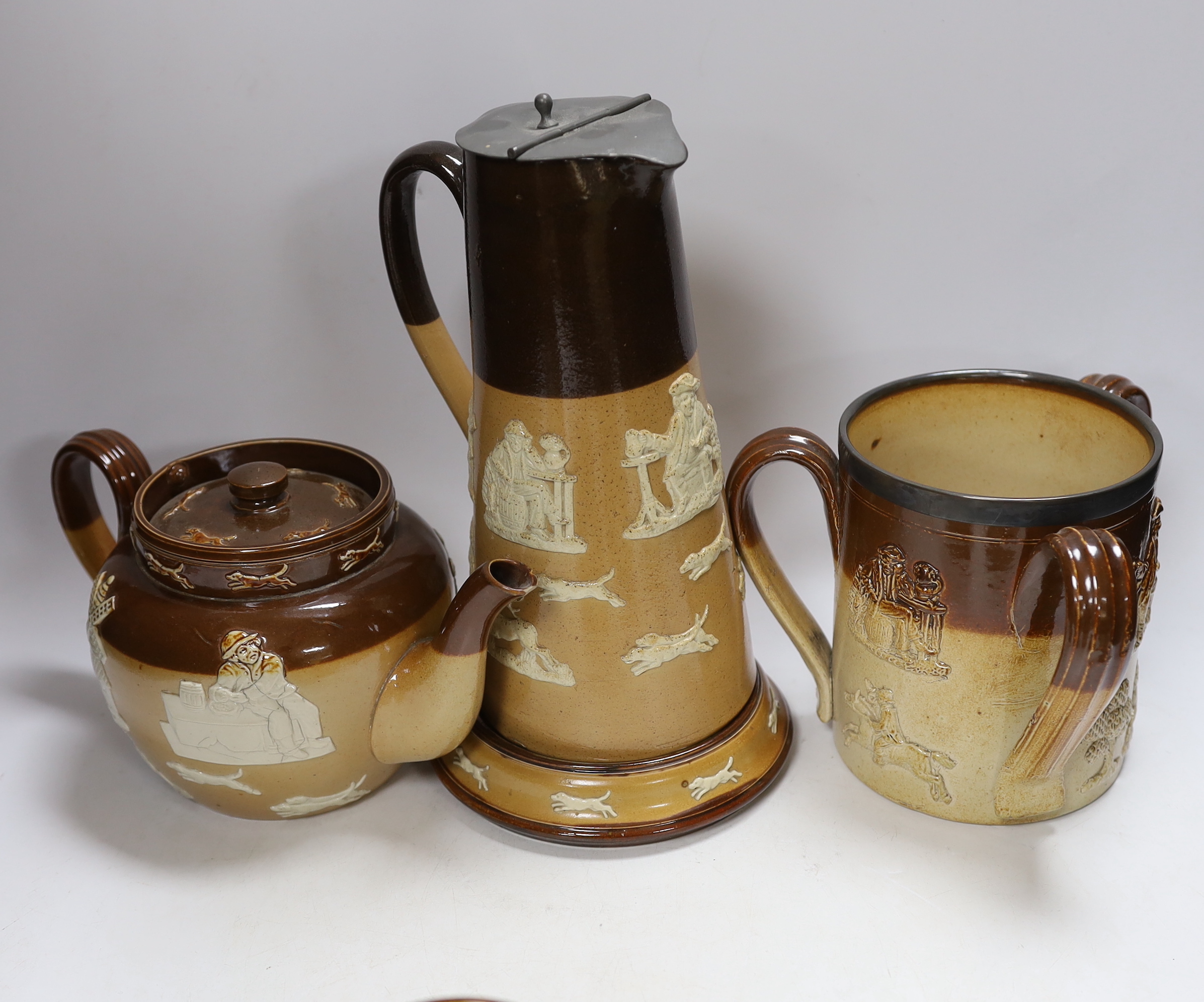 Seven items of mixed Doulton stoneware including a silver mounted tyg, largest 27cm high